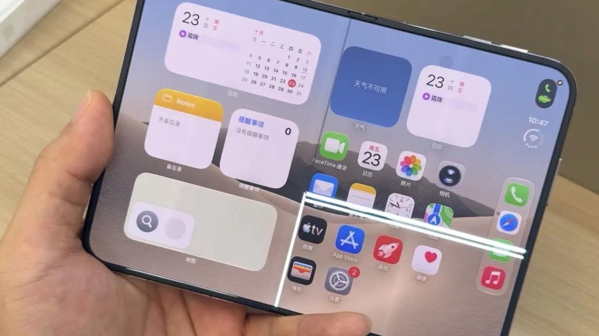 A hand holds an unfolded iPhone Duo displaying a crack along the vertical hinge and a bright white horizontal line across the screen.