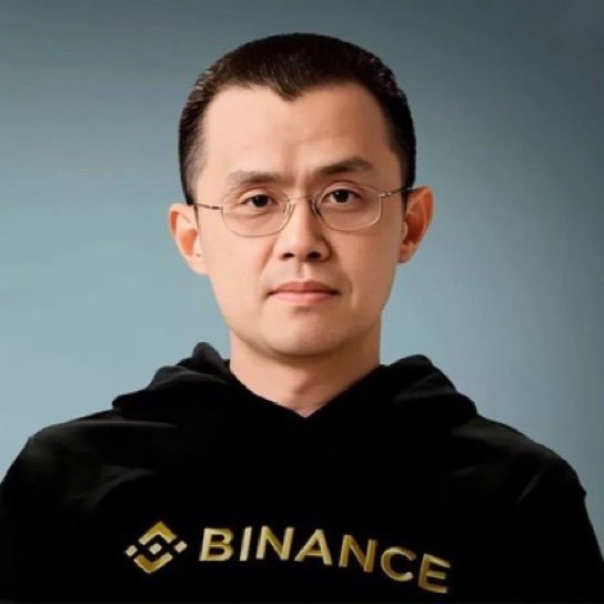 Portrait of Binance co-founder Changpeng Zhao wearing glasses and a black Binance hoodie.