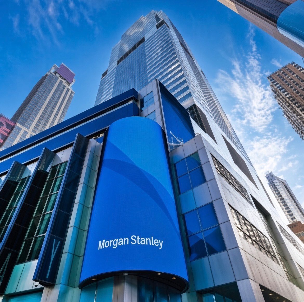 A low-angle view of a Morgan Stanley building featuring blue signage on a sunny day.