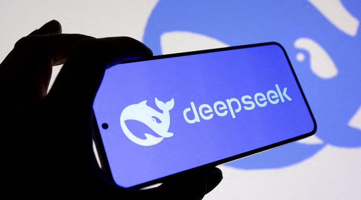 A hand holding a smartphone displaying the DeepSeek logo and name on its screen