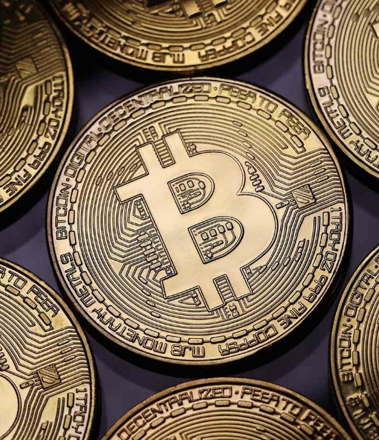 Close-up view of gold-colored physical Bitcoin tokens