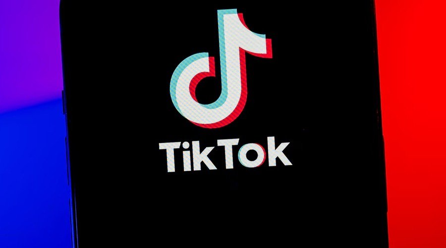A smartphone screen displaying the TikTok logo against a split blue and red background.