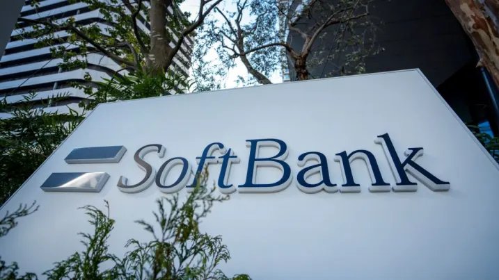 SoftBank company sign outside an office building surrounded by greenery