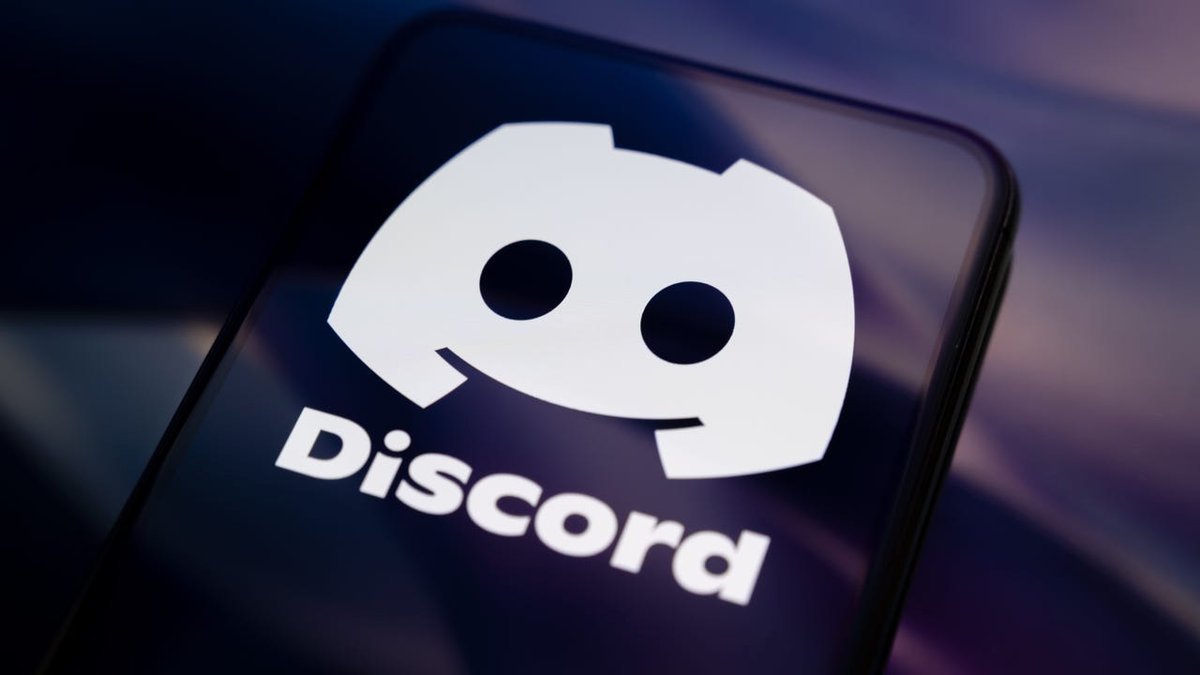 A smartphone screen displaying the white Discord logo and wordmark against a dark background.