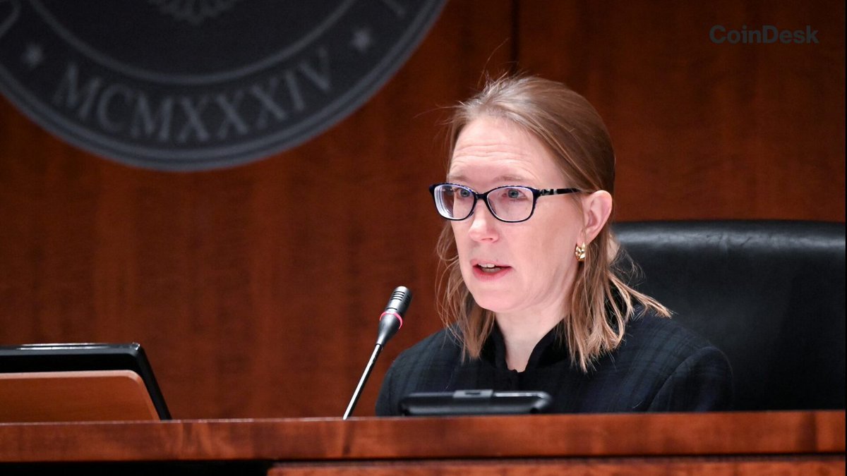 SEC Commissioner Hester Peirce speaking into a microphone at an official hearing or event.