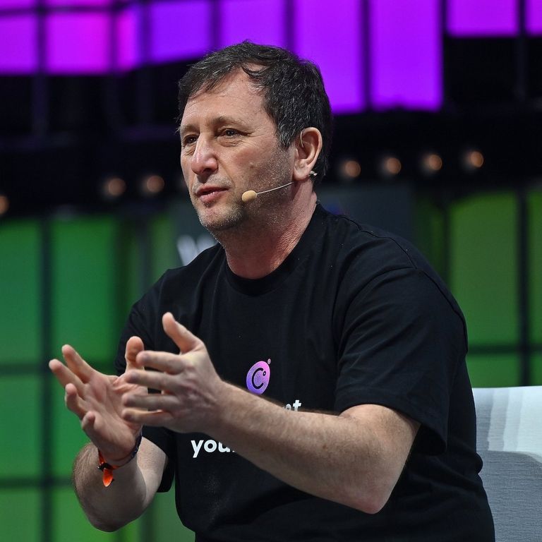 Former Celsius CEO Alex Mashinsky speaking with a microphone while wearing a Celsius t-shirt.