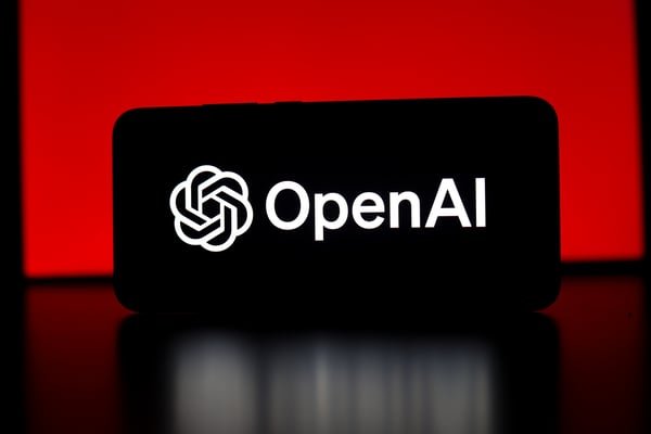 A smartphone screen displaying the OpenAI logo and name against a red illuminated background