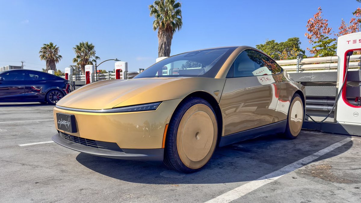 Tesla's gold-colored Cybercab parked near a Supercharger station.