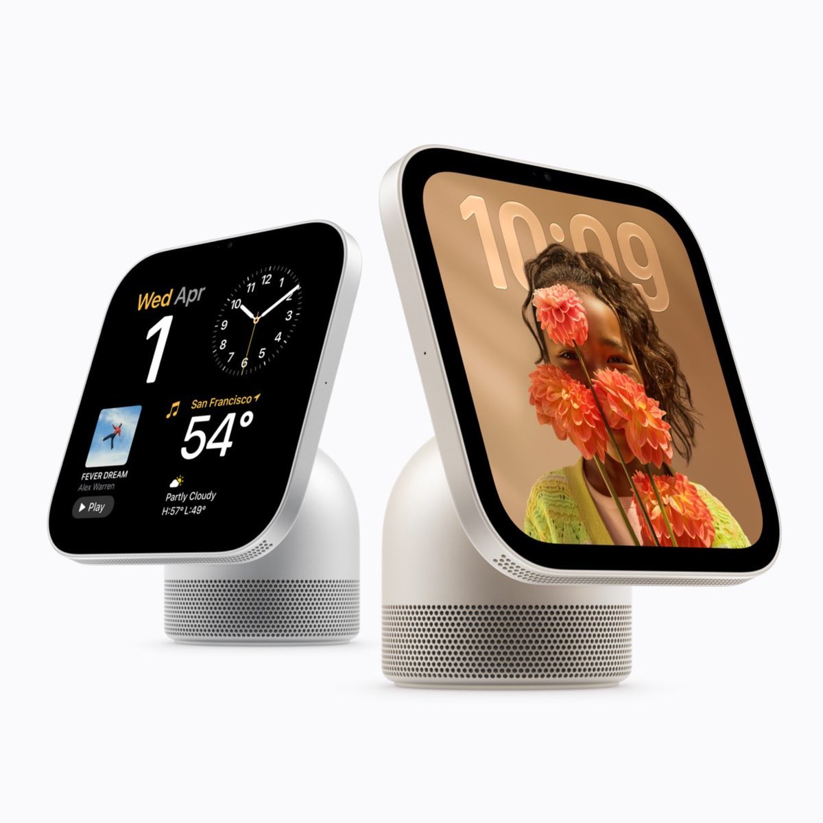 Two Apple HomeView smart home hubs with curved speaker bases and square touchscreens displaying a clock interface and a photo.