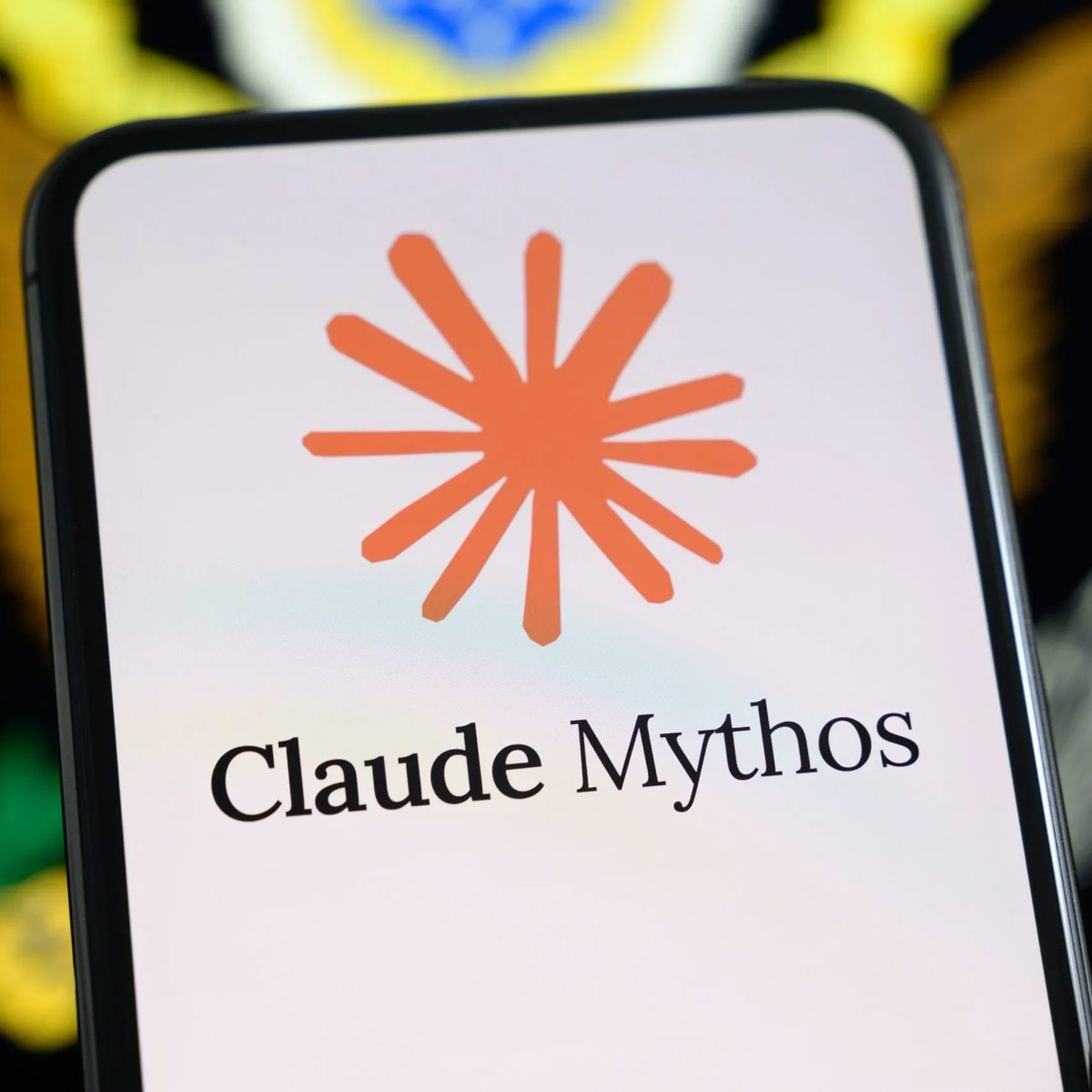 A smartphone screen displaying the Anthropic spark logo above the text 'Claude Mythos'.