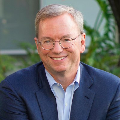 Portrait of former Google CEO Eric Schmidt wearing glasses and a navy blue blazer.
