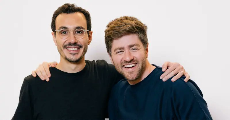 Portrait of Ramp co-founders smiling against a white backdrop.