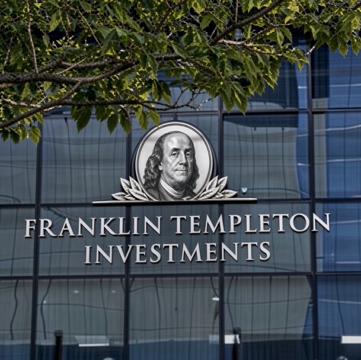 Exterior signage for Franklin Templeton Investments featuring the portrait logo of Benjamin Franklin on a glass building.