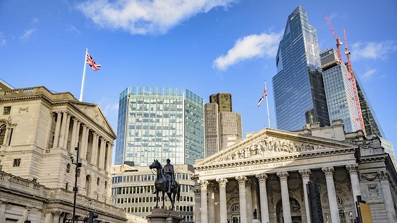 The Bank of England and Royal Exchange buildings in the City of London with modern skyscrapers in the background.