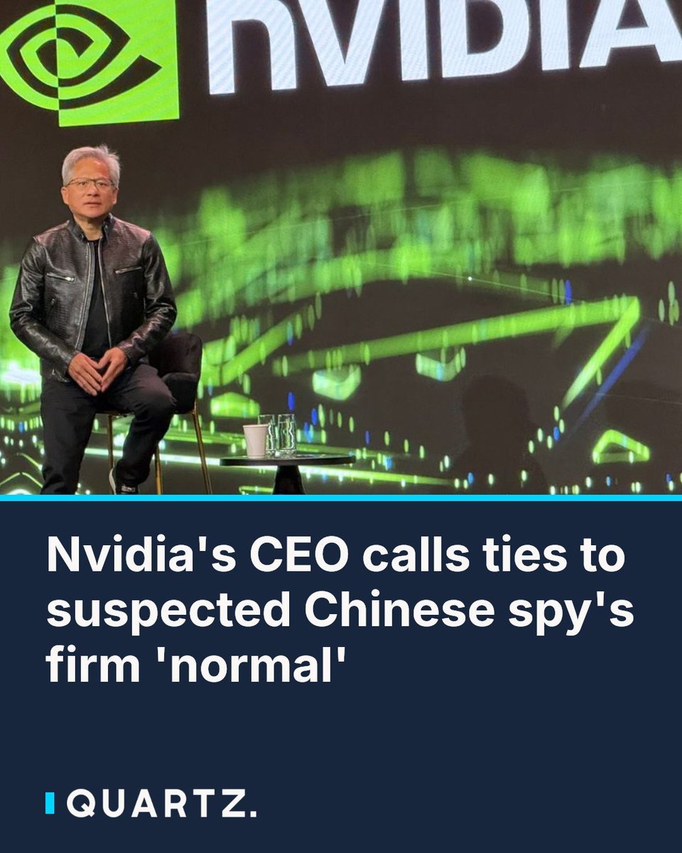 Nvidia CEO Jensen Huang seated on stage in front of an Nvidia backdrop.