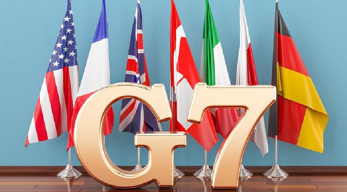Golden G7 letters positioned in front of flags of the Group of Seven member nations.