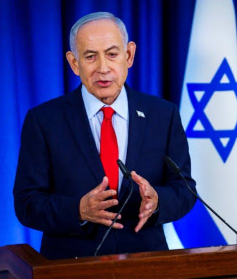 Israeli Prime Minister Benjamin Netanyahu speaking at a podium in front of the Israeli flag.