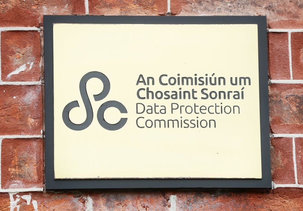 A plaque mounted on a red brick wall reads An Coimisiún um Chosaint Sonraí, Data Protection Commission, featuring its circular logo.