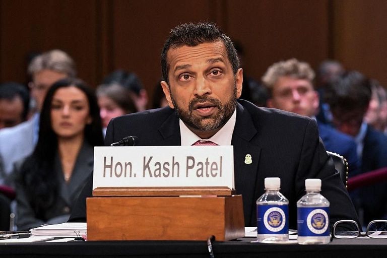 FBI Director Kash Patel seated at a hearing table with a nameplate in front of him.