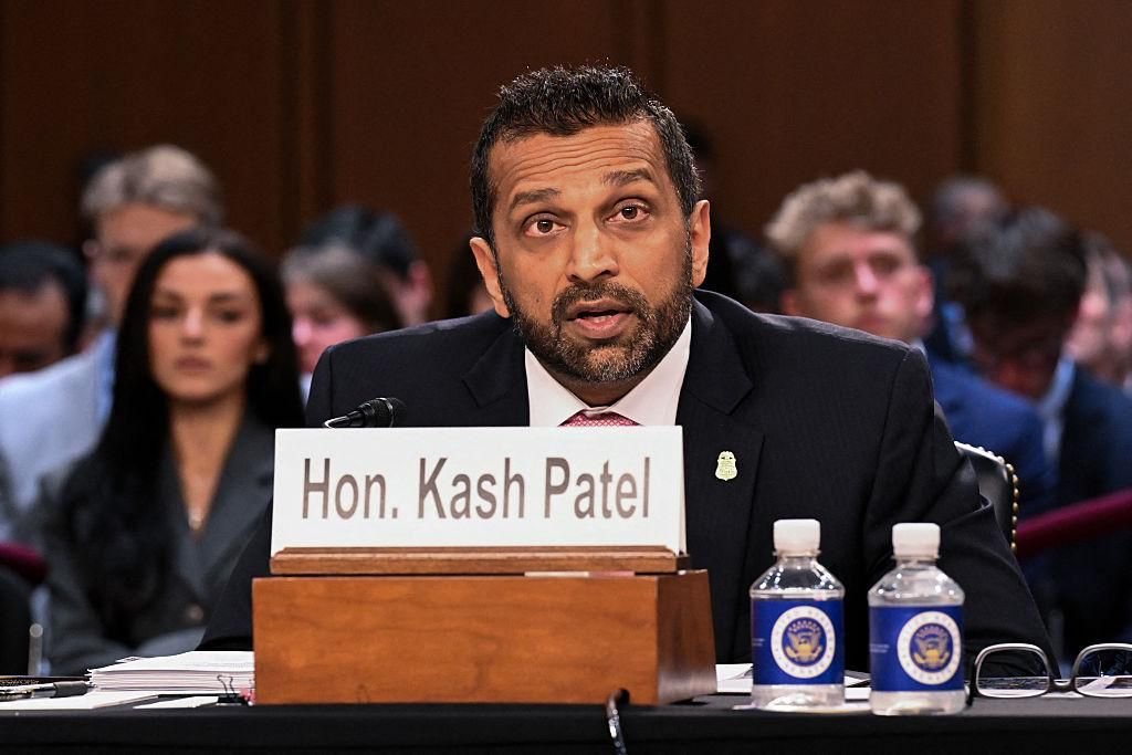 FBI Director Kash Patel seated at a hearing table with a nameplate in front of him.