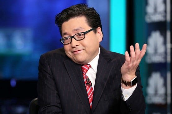 Photograph of Bitmine Chairman Tom Lee wearing a suit and glasses, speaking on a television set.