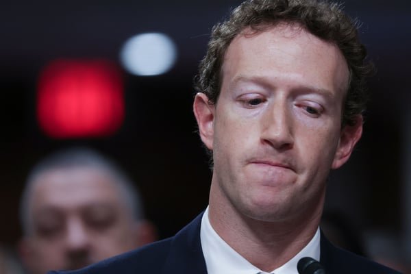 A close-up portrait of Meta CEO Mark Zuckerberg looking downward.