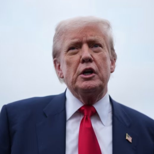 Portrait of Donald Trump wearing a dark suit and red tie