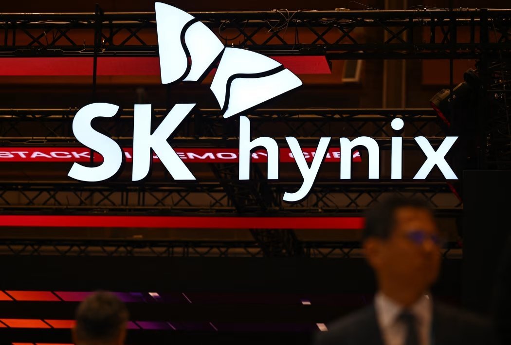 An illuminated SK Hynix logo sign displayed above an event or conference floor.