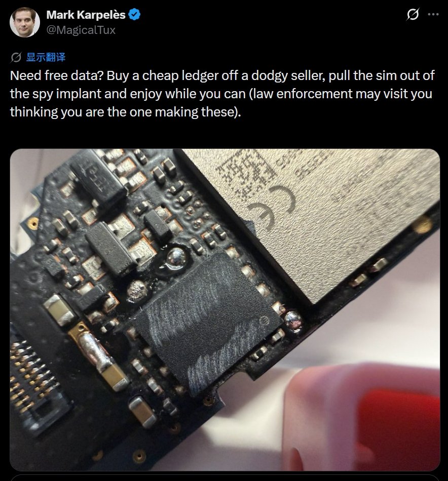 A close-up view of a disassembled hardware wallet circuit board showing an unauthorized microchip implant.