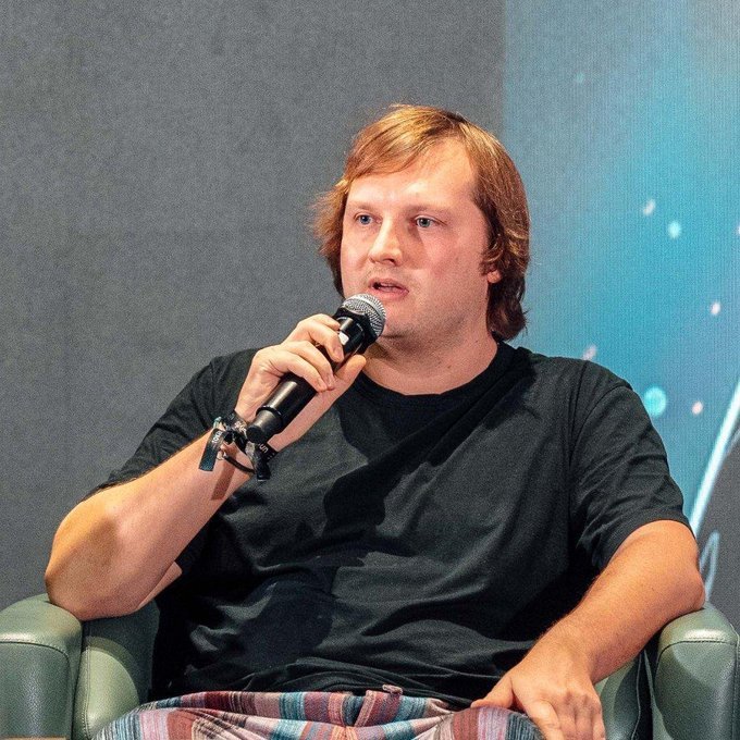 Aave founder Stani Kulechov speaking with a microphone while seated on a panel