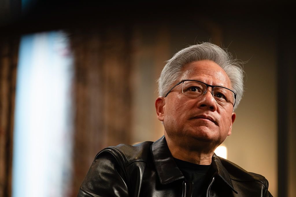 Portrait of Nvidia CEO Jensen Huang wearing glasses and a black leather jacket.