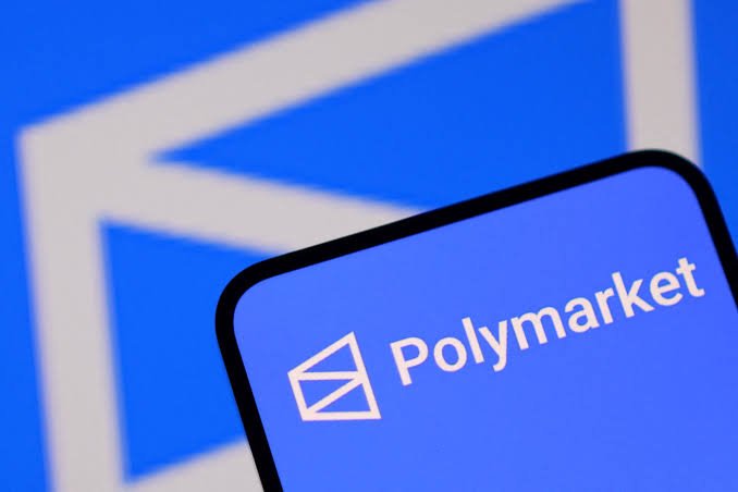 A smartphone screen displaying the Polymarket logo against a blue background.