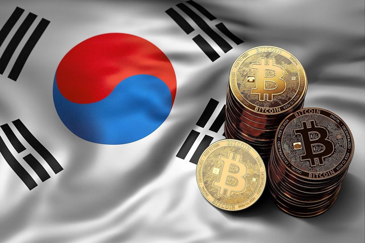 Physical Bitcoin commemorative coins resting on a South Korean national flag.