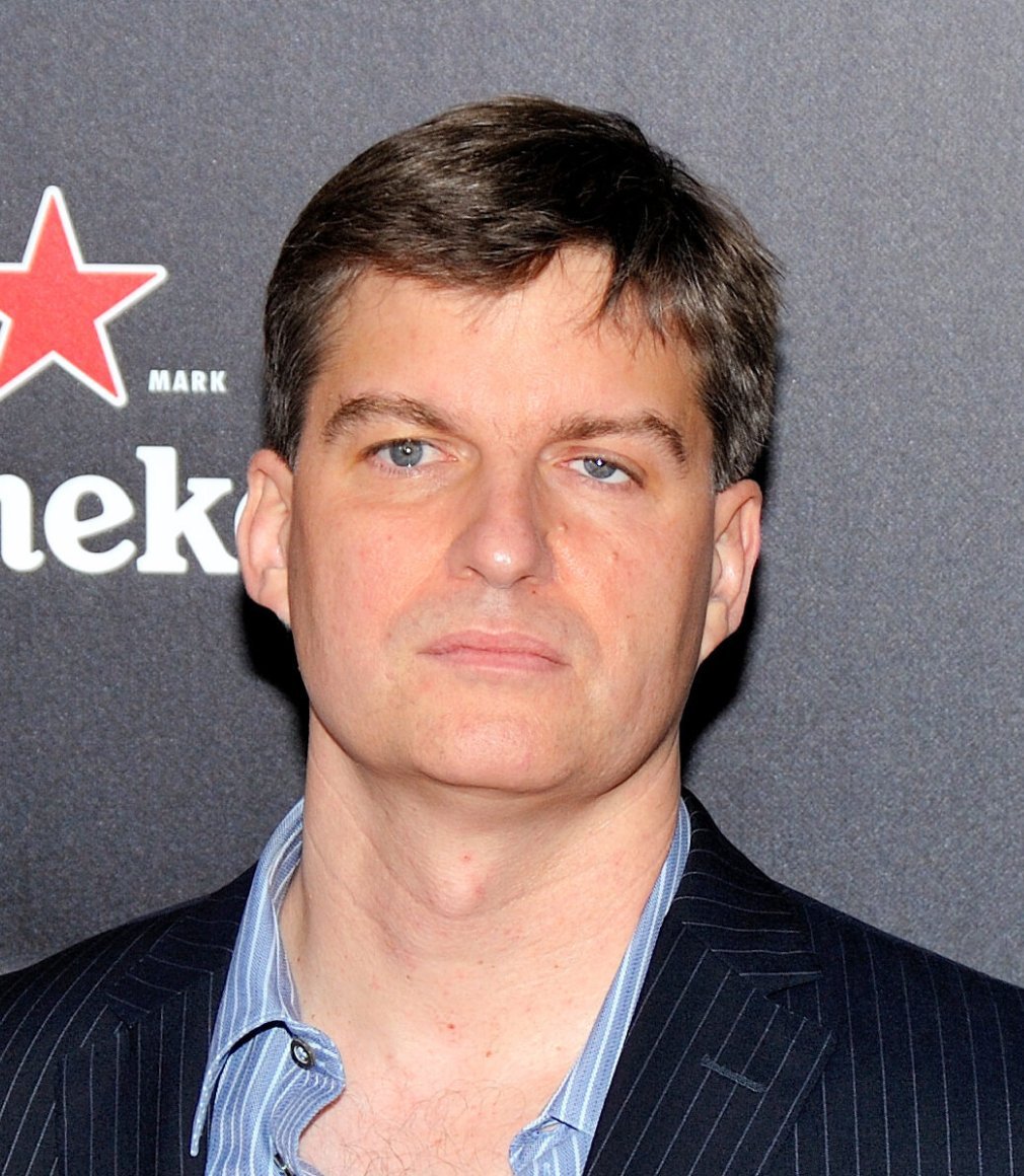 Portrait of investor Michael Burry in a striped collared shirt and dark suit jacket.