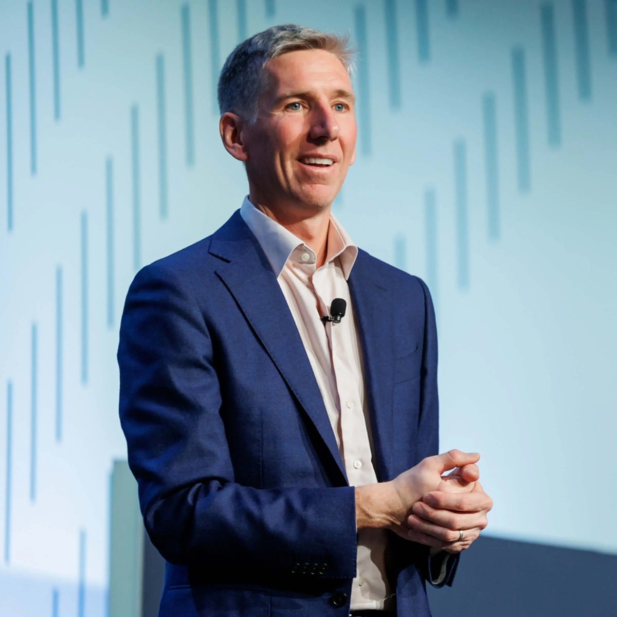Bitwise Chief Investment Officer Matt Hougan in a blue suit speaking on stage.