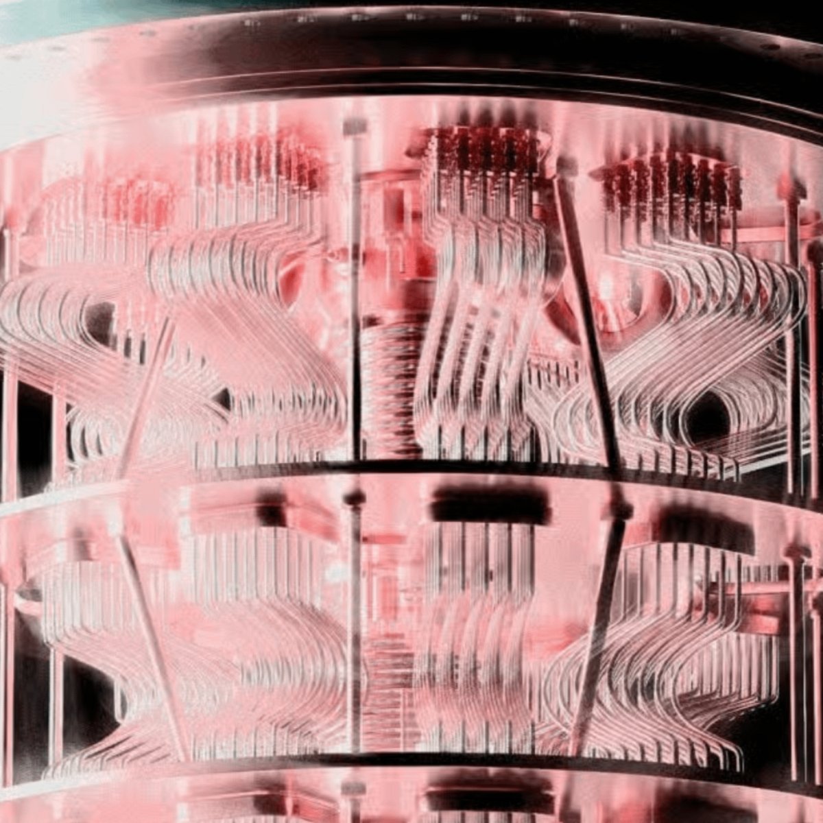 A close-up view of the internal wiring and stages of a quantum computer dilution refrigerator bathed in pinkish light.