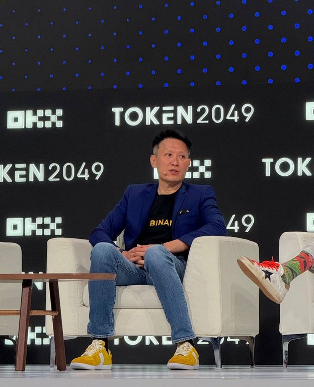 Binance CEO Richard Teng seated on stage during a panel at the TOKEN2049 conference.