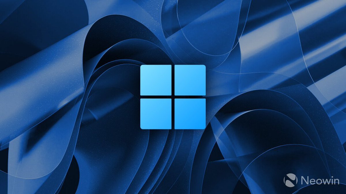 A blue Microsoft Windows 11 logo centered over the flowing blue Bloom wallpaper.