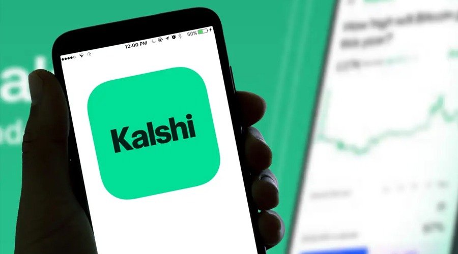 A smartphone displaying the Kalshi logo on its screen.