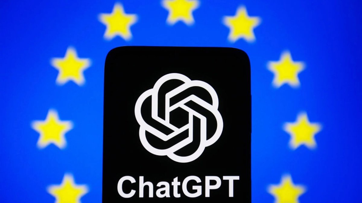 A smartphone displaying the ChatGPT logo placed against a blurred European Union flag.