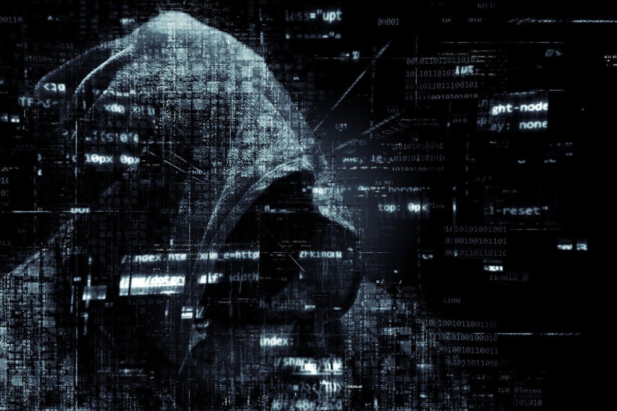 Digital illustration of a hooded hacker silhouette overlaid with streams of code and computer data.
