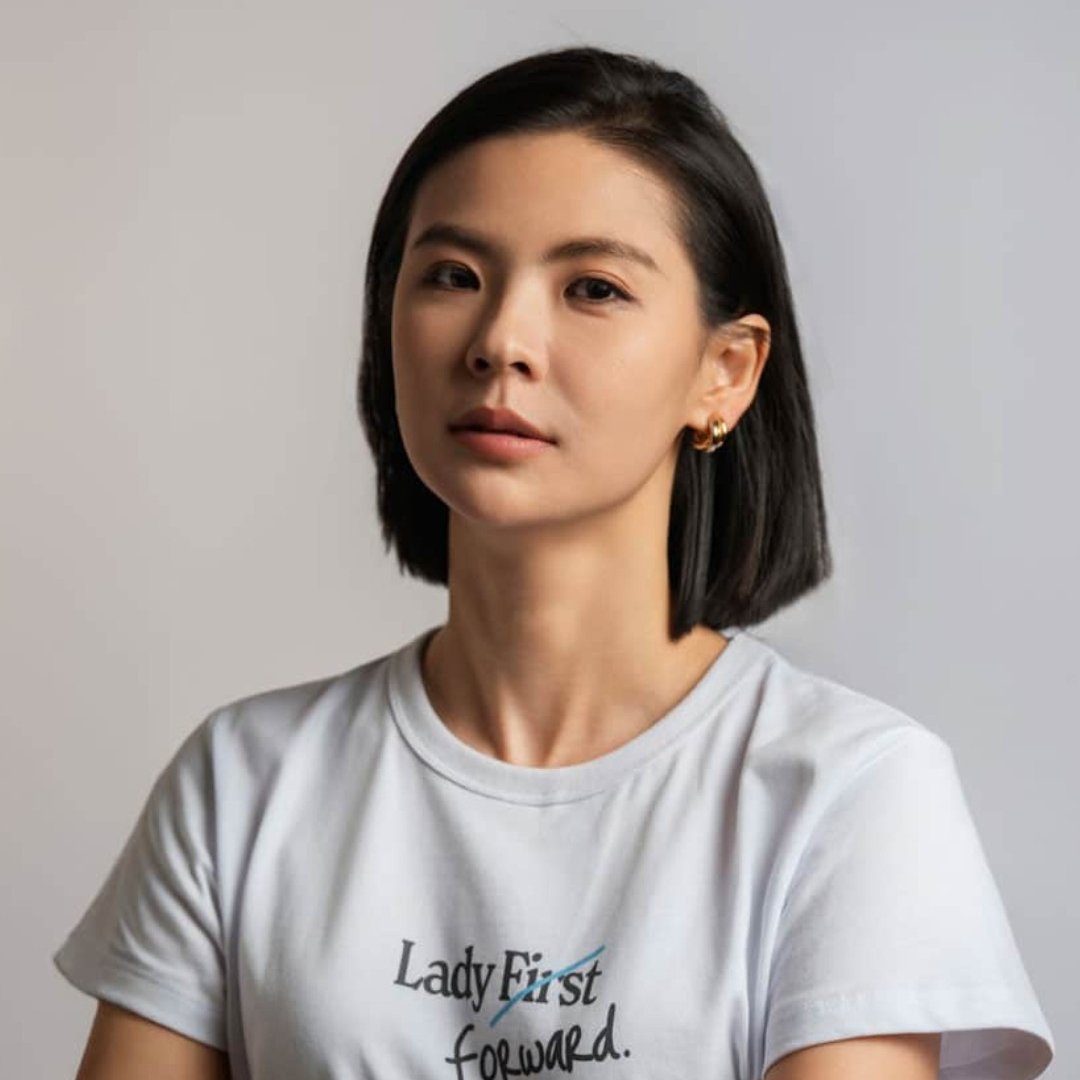 Portrait of Bitget CEO Gracy Chen wearing a white t-shirt.