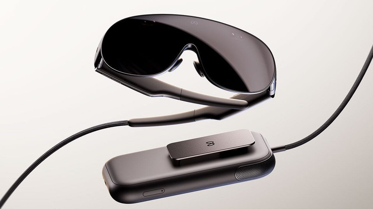 Product render of the Meta VR glasses showing the lightweight visor connected by cable to a compact external processing pack.
