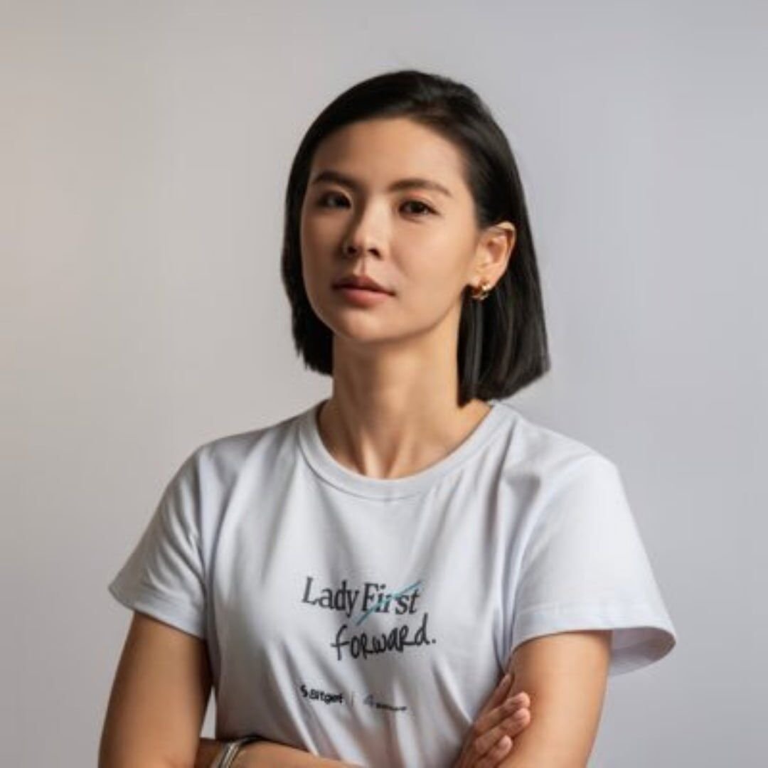 Portrait photo of Bitget CEO Gracy Chen wearing a white t-shirt against a plain background.