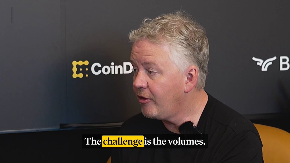 Cloudflare CEO Matthew Prince speaking in an interview with CoinDesk, with a subtitle reading 'The challenge is the volumes.'