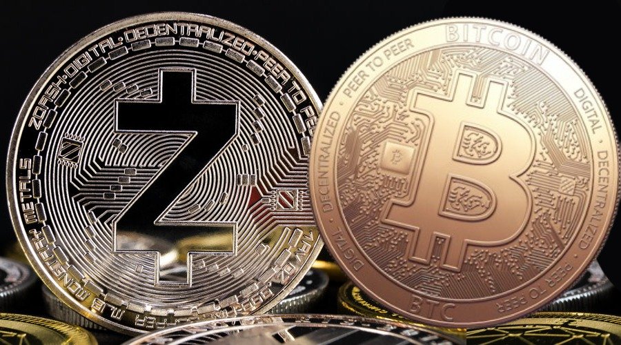 Physical commemorative tokens representing Zcash and Bitcoin placed side by side.