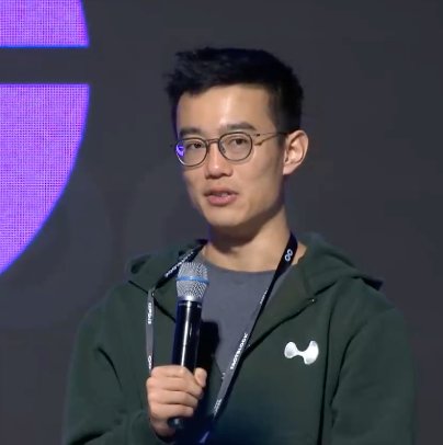Close-up of Hyperliquid co-founder Jeff Yan speaking into a microphone while wearing glasses and a green hoodie.