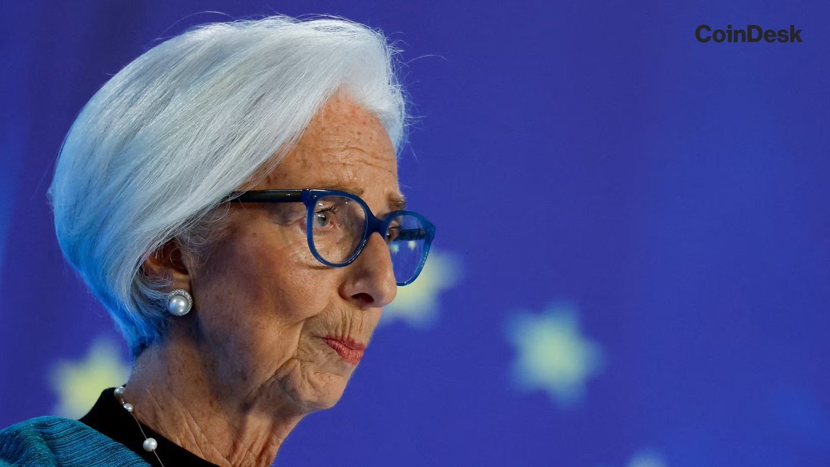 Portrait of European Central Bank President Christine Lagarde wearing glasses and pearl earrings against a blue European flag backdrop.