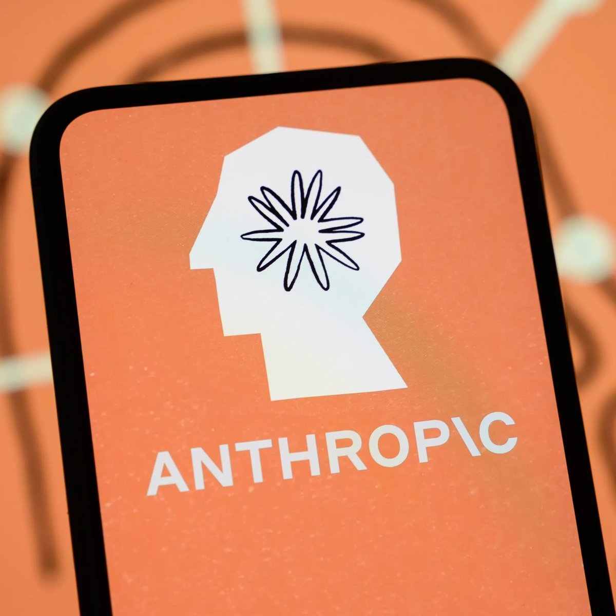 A smartphone screen displaying the Anthropic company logo and name on an orange background.